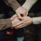 two people holding hands in a caring way, indoors